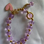 Cute purple beaded bracelet for girls with pink heart charm and gold detailing